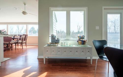 a living room with a white coffee table and windows at 2-Acre Highland Park Retreat with Heated Pool ~ 5* in Highland Park