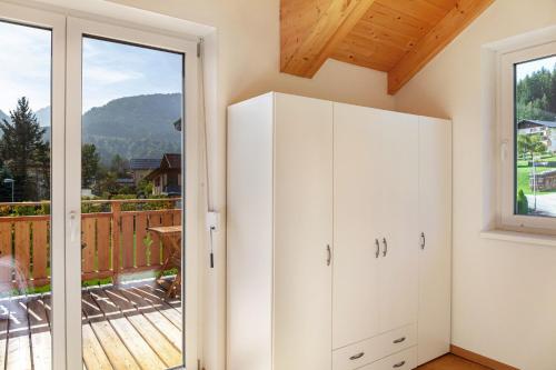 a room with a door open to a balcony at Bubbelen aan de piste in Kötschach
