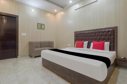 a bedroom with a large bed with red pillows at Hotel Valley Wood Inn in Rājpur