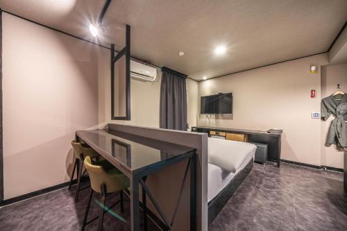 a hotel room with a bed and a desk at HOTEL STAY AYANA DAEJEON in Daejeon