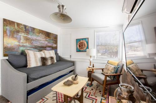 a living room with a couch and a table at JT's Star Catcher Cabin - HOT TUB in Yucca Valley