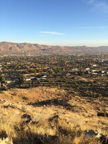 a view of a city from the top of a hill at JT's Star Catcher Cabin - HOT TUB in Yucca Valley