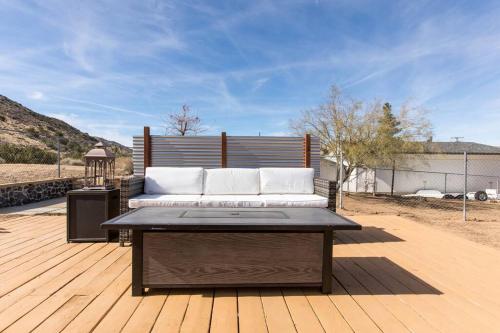 a bed sitting on top of a wooden deck at JT's Star Catcher Cabin - HOT TUB in Yucca Valley