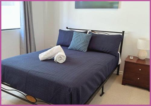 a bed with two towels on top of it at Marina Views On Melton | 107/3 Melton Terrace Townsville in Townsville