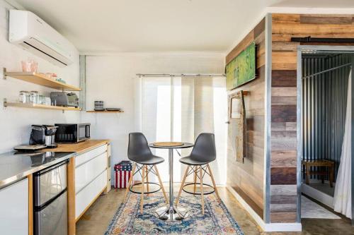 a kitchen with two stools and a table in a room at JT's Star Catcher Cabin - HOT TUB in Yucca Valley