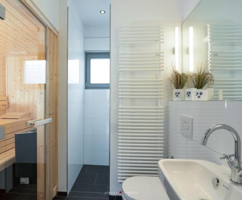 a bathroom with a sink and a toilet at Ostsee - Reetdachhaus Nr 8 "Sonne und mehr" im Strand Resort in Heiligenhafen