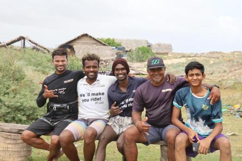 a group of men sitting on a bench at De Silva Palm Resort in Kalpitiya