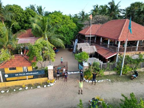 a group of people standing in front of a building at De Silva Palm Resort in Kalpitiya