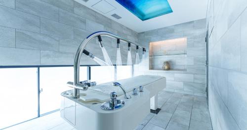 a white bathroom with a sink and a mirror at GOTO RETREAT by Onko Chishin in Goto