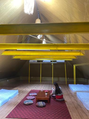 a room with beds and a table in a tent at Wind's House Ha Giang in Ha Giang