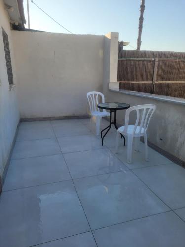 a patio with two chairs and a table on a balcony at Newly Renovated Home in Bet Shemesh Vatika in Beit Shemesh