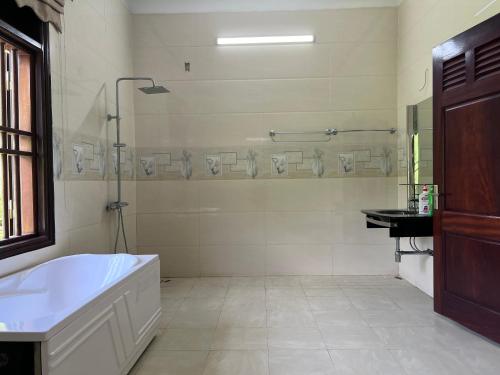 a large bathroom with a tub and a shower at Wind's House Ha Giang in Ha Giang