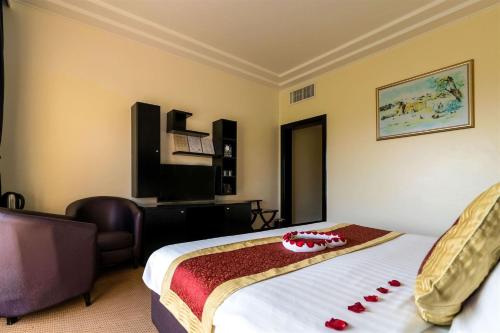 a hotel room with a bed with red decorations on it at Royal Beach Hotel & Resort in Dibba