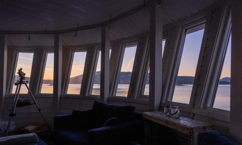 a living room with a view of the ocean at Norwegian Wild in Vangsvik
