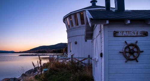 a small building next to a body of water at Norwegian Wild in Vangsvik