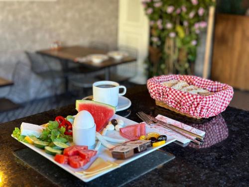 a table with a plate of food and a cup of coffee at Meridiani Taksim Hotel in Istanbul