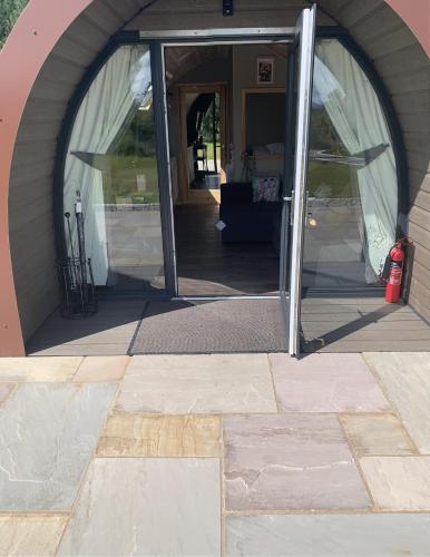 an entrance to a tent with a door open at Tawny Owl Pod with Hot Tub in Oban