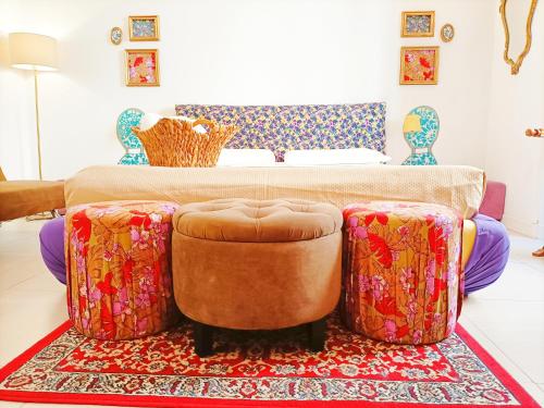 a living room with a couch and two ottomans at Festina Lente in Rome