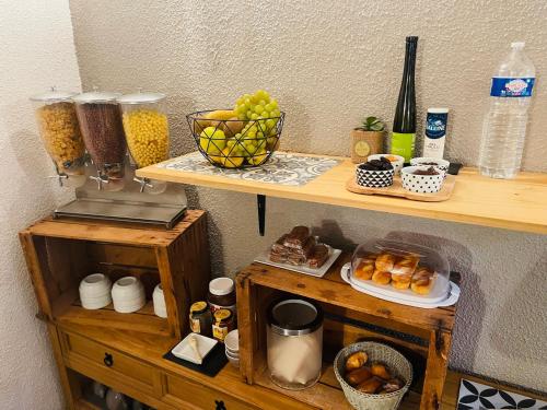 a wooden shelf with a bunch of food on it at H&ocirc;tel De La Loge in Perpignan