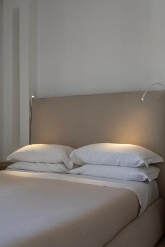 a bed with two white pillows and a headboard at Tra Cielo e Mare in Vieste