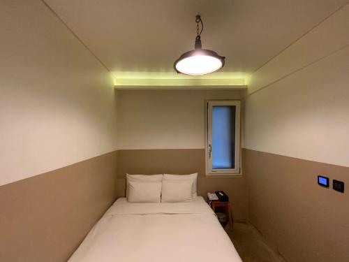 a small room with a bed and a light at 31page in Seoul