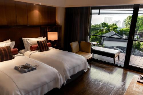 Postel nebo postele na pokoji v ubytování Grand View Resort Beitou