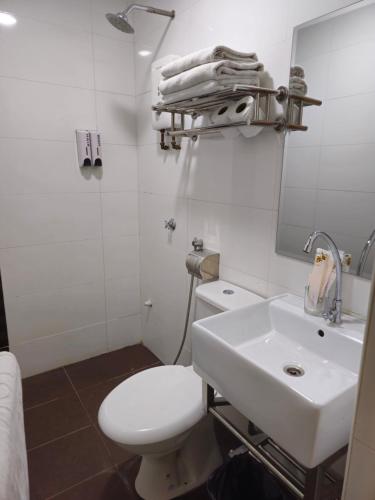 a bathroom with a white toilet and a sink at Fortune Hotel in Johor Bahru