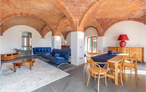 a living room with a table and chairs and a couch at Corte Liliana in Montegabbione