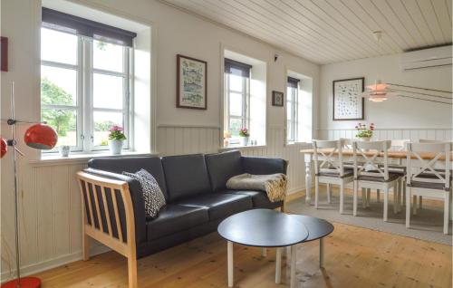 a living room with a couch and a table at Holiday Home Hodde With Fireplace in Tistrup