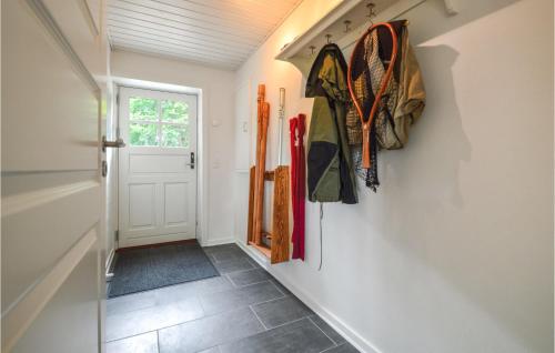 a hallway with umbrellas hanging on the wall at Holiday Home Hodde With Fireplace in Tistrup