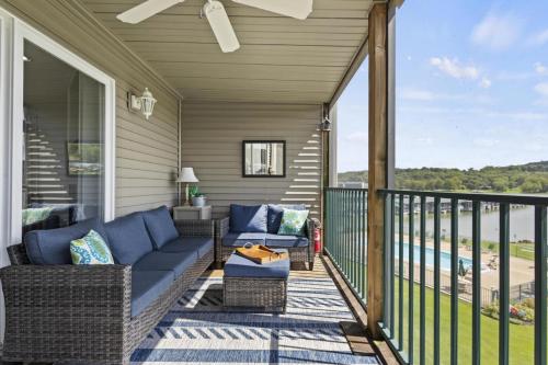a porch with a couch and chairs on a balcony at Quietside in Camdenton