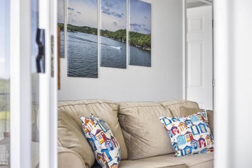 a couch in a living room with paintings on the wall at Quietside in Camdenton