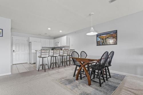 a dining room and kitchen with a table and chairs at Quietside in Camdenton