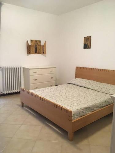 a bedroom with a bed and a dresser at Vacation home Controra, Ginosa (TA) in Ginosa