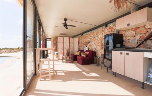 a kitchen and living room with a stone wall at House Near Golf Course in Murcia