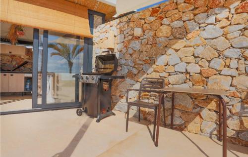 a stone wall in a kitchen with a stove at House Near Golf Course in Murcia