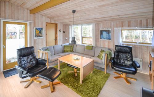 a living room with a couch and two chairs and a table at Holiday Home Kalvehavestien Glesborg Vi in Fjellerup Strand