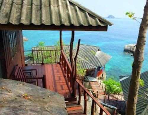a house with a view of the ocean at OK2 Mamajim Bungalows in Koh Tao
