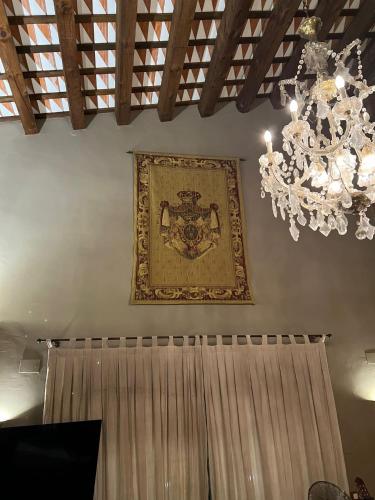 a picture hanging on the wall with a chandelier at Villa Sol Luxury Costa Brava Golf in Peralada
