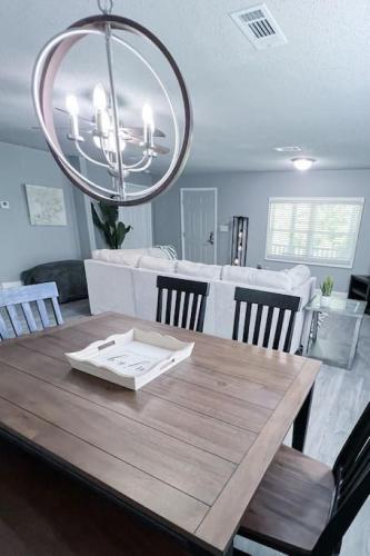 a dining room with a wooden table and a chandelier at Serenity Springs in Hot Springs