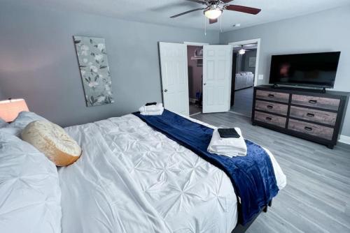 a bedroom with a large bed and a flat screen tv at Serenity Springs in Hot Springs