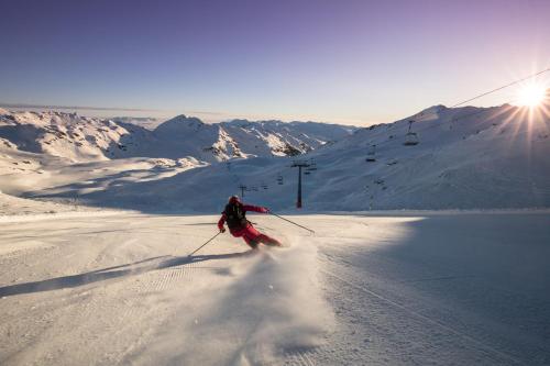 a person is skiing down a snow covered mountain at Landhaus Sabine in Zellberg