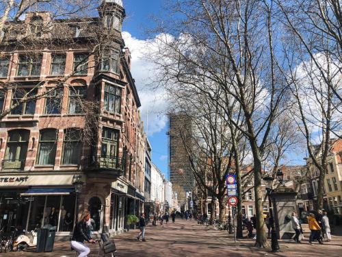 a city street with people walking down the street at The Hunfeld in Utrecht
