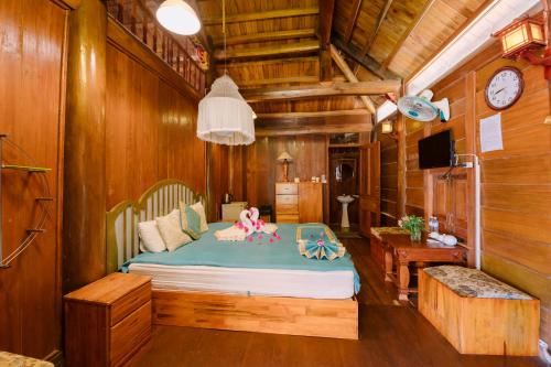 a bedroom with a bed with a doll on it at Memory Villa in Da Lat