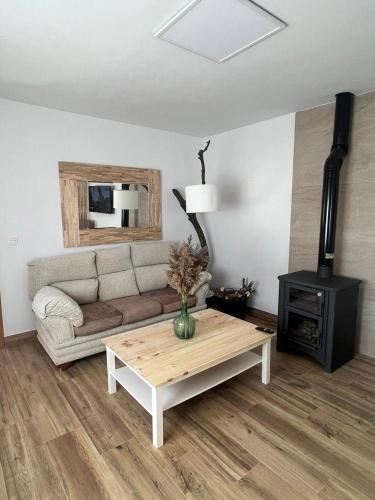 a living room with a couch and a coffee table at Casa La Chicuela in Lapeza