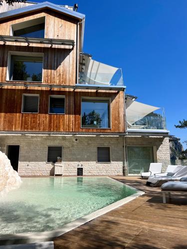 a house with a swimming pool in front of it at La Forestale Luxury Ecolodge B&B Primo Piano in Acqualagna
