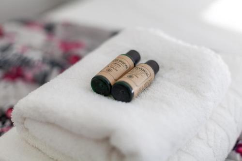 twoopened champagne bottles sitting on a pile of towels at Hidden Gem, Bright 1BR flat wPatio in Lambeth in London