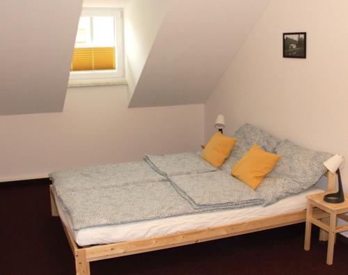 a bed with two yellow pillows in a room at Stadtwohnung in Calau (Spreewald) in Calau