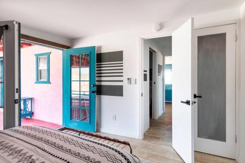 a room with a bed and a room with doors at KAMPINK! Pool, Spa, Gameroom Compound with Amazing Views on 2.5 Acres in Joshua Tree