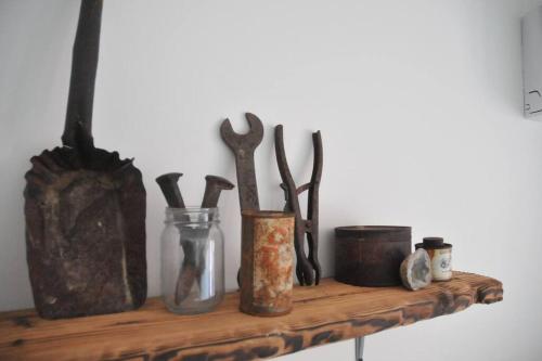 a wooden shelf with various utensils on it at KAMPINK! Pool, Spa, Gameroom Compound with Amazing Views on 2.5 Acres in Joshua Tree
